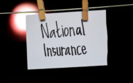 The words 'national insurance' written on a piece of paper pegged to a clothes line