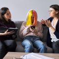 Two professionals in discussion regarding a young woman