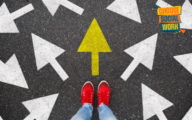 Image of feet standing in front of multiple white arrows in different directions - one yellow arrow facing forward