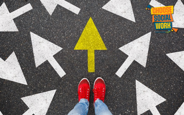 Image of feet standing in front of multiple white arrows in different directions - one yellow arrow facing forward