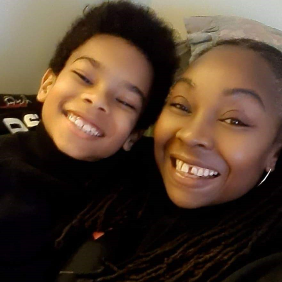 Sharon smiling alongside her young grandson.