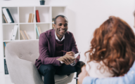 social worker speaking to two teenagers during a visit